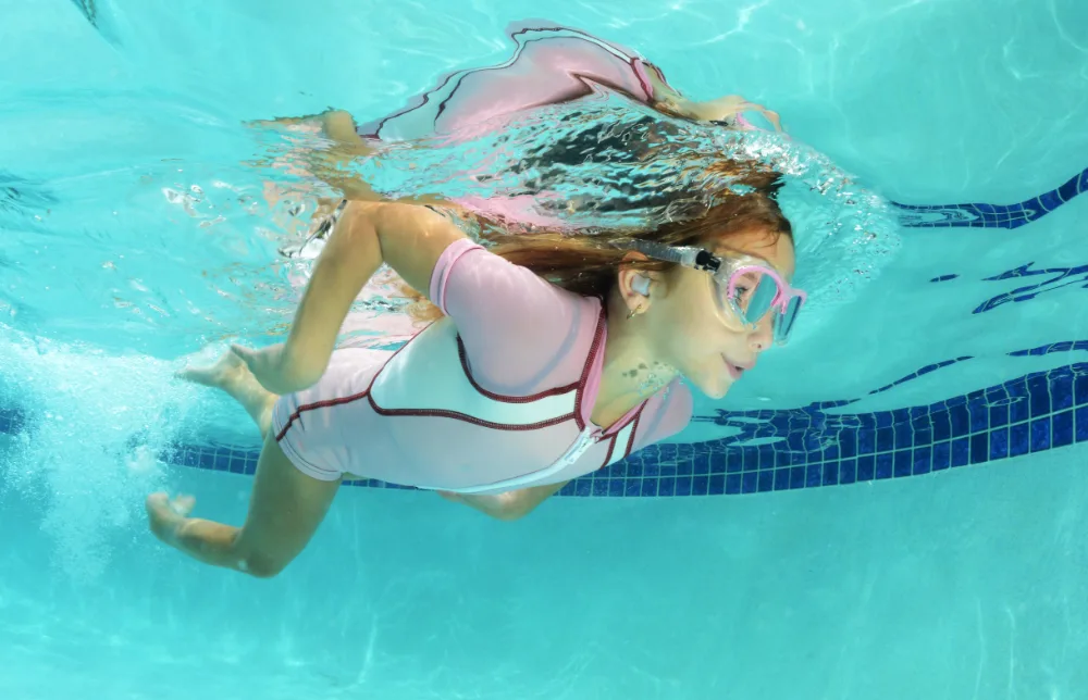 Ear plugs on child swimming