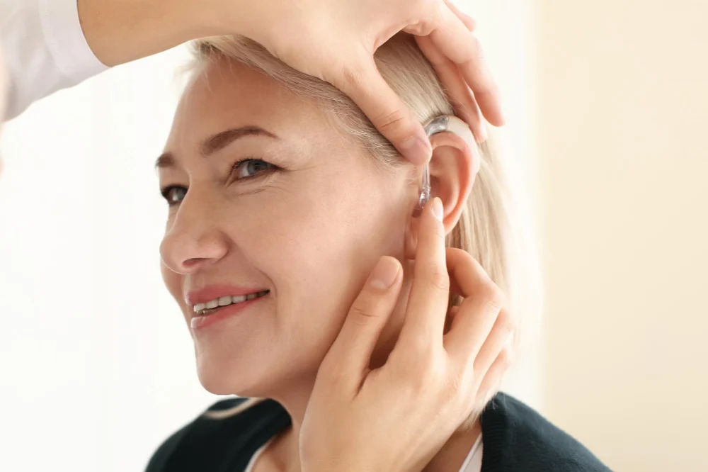audiologist fitting hearing device