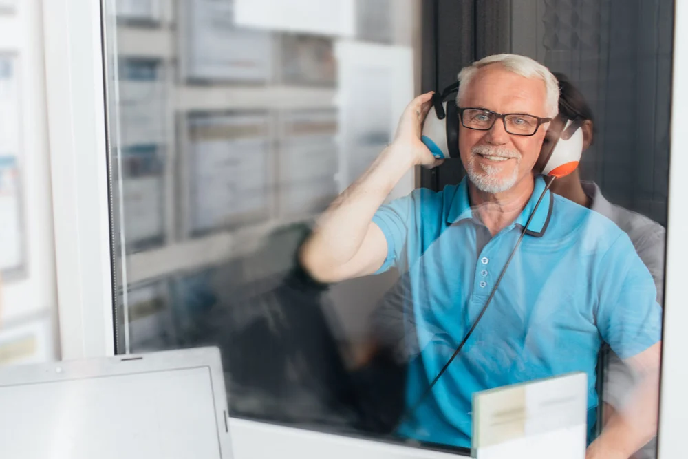 senior man at audiology testing